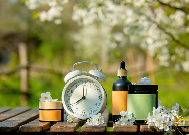 alarm-clock-and-cosmetic-bottle-and-jar-on-wooden-2026-03-09-07-16-35-utc 1